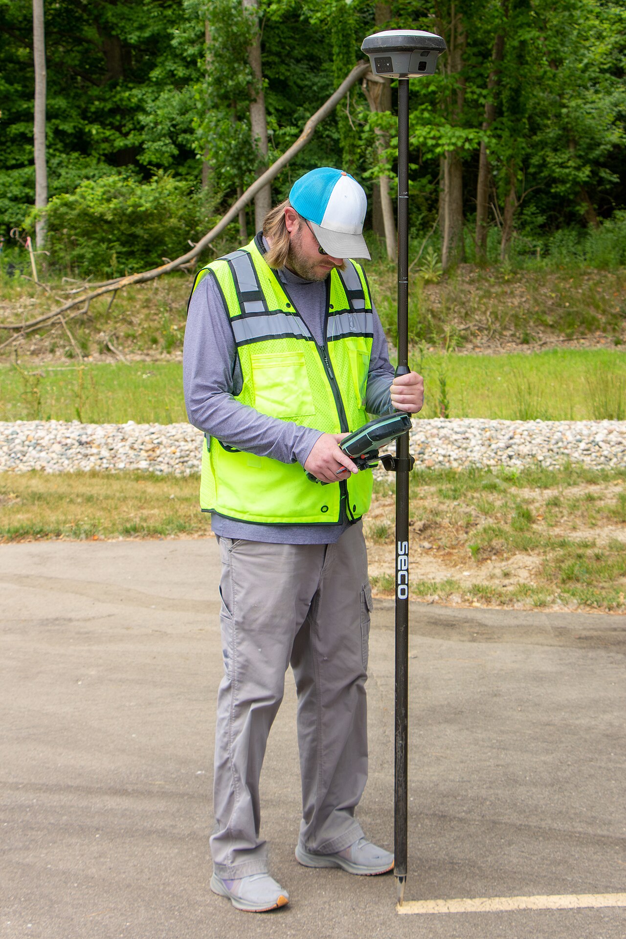 A surveyor using a GNSS receiver with an RTK solution to establish precise ground truth.